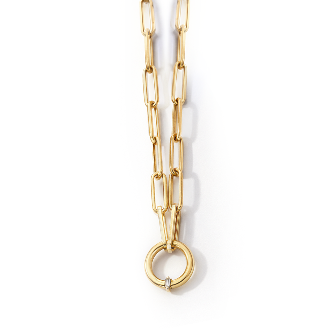 Gold necklace with a unique ring pendant on a white background, branded 'Charmaliena'.